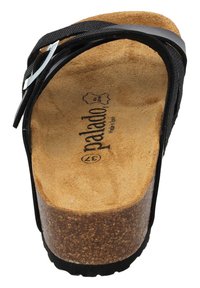 Black sandal with crossed straps, cork footbed, and rubber sole. Features a silver-tone buckle and textured insole. Size marked inside.
