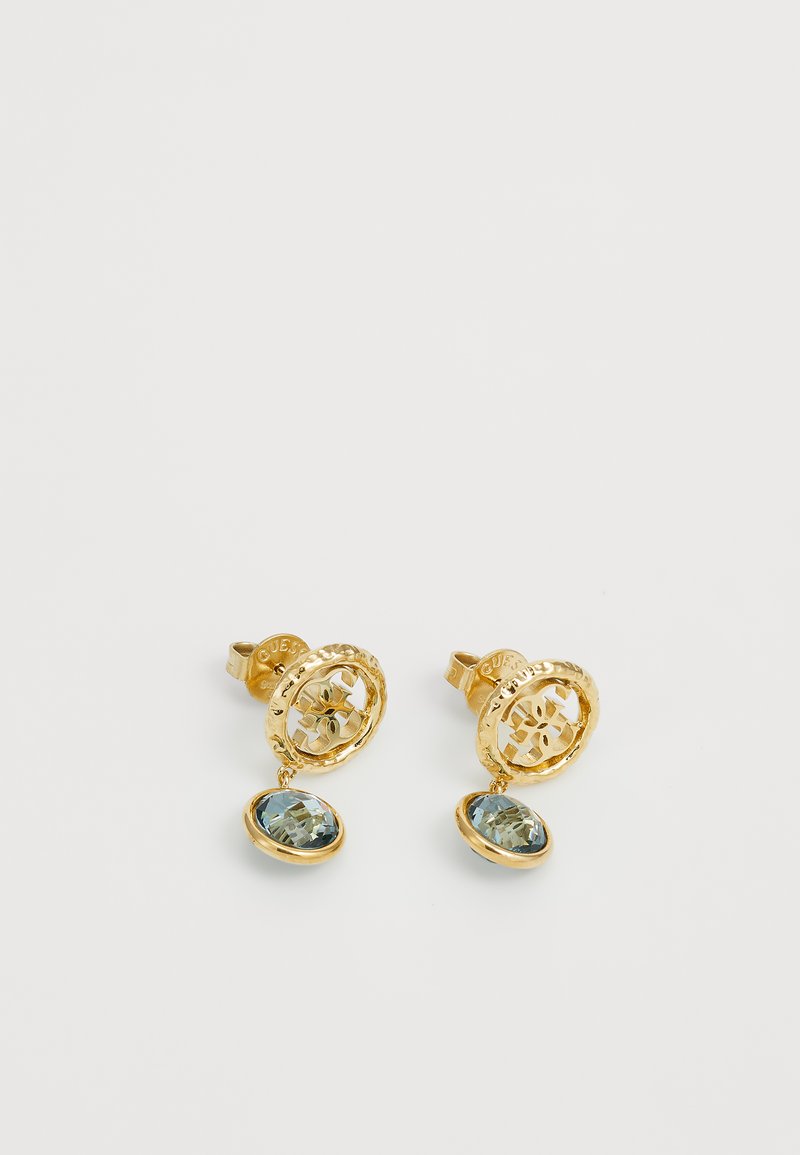 Boucles d'oreilles dorées présentant un design en filigrane circulaire avec des accents en cristal bleu, suspendues à un support sécurisé pour une sensation légère.