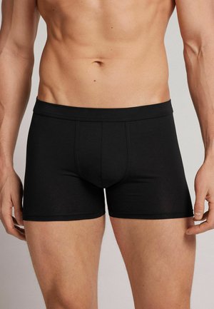 Schwarze Boxer-Briefs aus weicher, dehnbarer Stoff. Mit eng anliegendem Schnitt, elastischem Bund und einem Frontbeutel für Unterstützung.