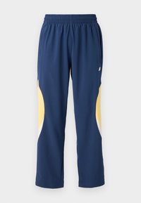 Marineblauwe sportbroek met een elastische tailleband. Bevat gele en witte gebogen accenten aan de zijkanten. Zachte, gladde stof.