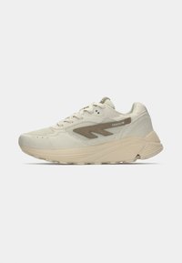 Light beige athletic shoe with a textured upper, featuring a brown accent and a thick, cushioned sole designed for comfort and support.