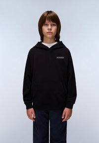 Un sweat à capuche noir avec une poche avant et un cordon de serrage, arborant un petit logo imprimé sur la poitrine. Assorti à un pantalon bleu foncé.