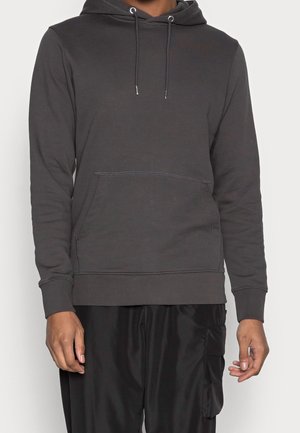 Male wearing dark gray hooded sweatshirt with front pocket and black cargo pants with side pocket, shown from neck to mid-thigh.