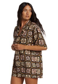 Short-sleeve shirt featuring a multicolored floral pattern on a black background, with a relaxed fit and a notched collar.