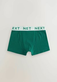 Zöld pamut boxer alsónadrág fehér derékrésszel, amelyen a "NEXT" felirat található. Sima textúra, standard szabás és további minták nélkül.
