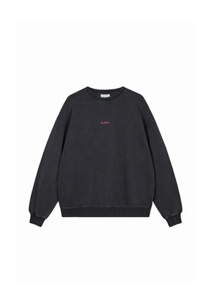 Black long-sleeve sweatshirt with ribbed cuffs and hem, featuring small pink "OH APRIL" text centered on the chest.