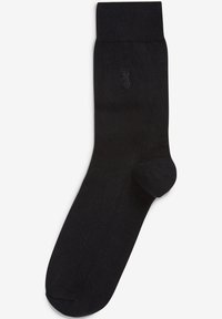 Schwarze Socke aus glattem Material mit einem gerippten Bündchen und einer nahtlosen Zehenpartie. Mit einem kleinen, geprägten Logo an der Seite.