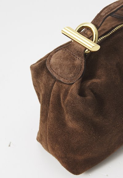 Brown suede handbag with a gold metal clasp, featuring a soft, gathered design. The texture is smooth and matte, highlighting craftsmanship details.