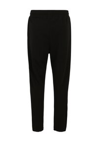 Sorte joggebukser lavet af blødt stof. Har en elastisk talje, tætsiddende bendesign og syede detaljer langs sømmene.