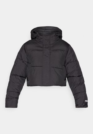 Cropped black puffer jacket with a hood, featuring quilted design, elastic cuffs, and subtle logo detail on the sleeve.