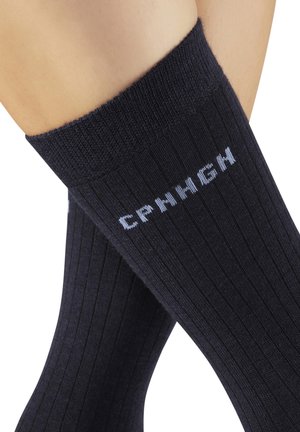 Black ribbed socks made of a soft material, featuring light blue lettering “CRMNCH” near the top. Comfortable fit with a textured finish.