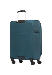 Valigia in tessuto blu con superficie testurizzata, manico retraibile, quattro ruote nere e una tasca con zip frontale.