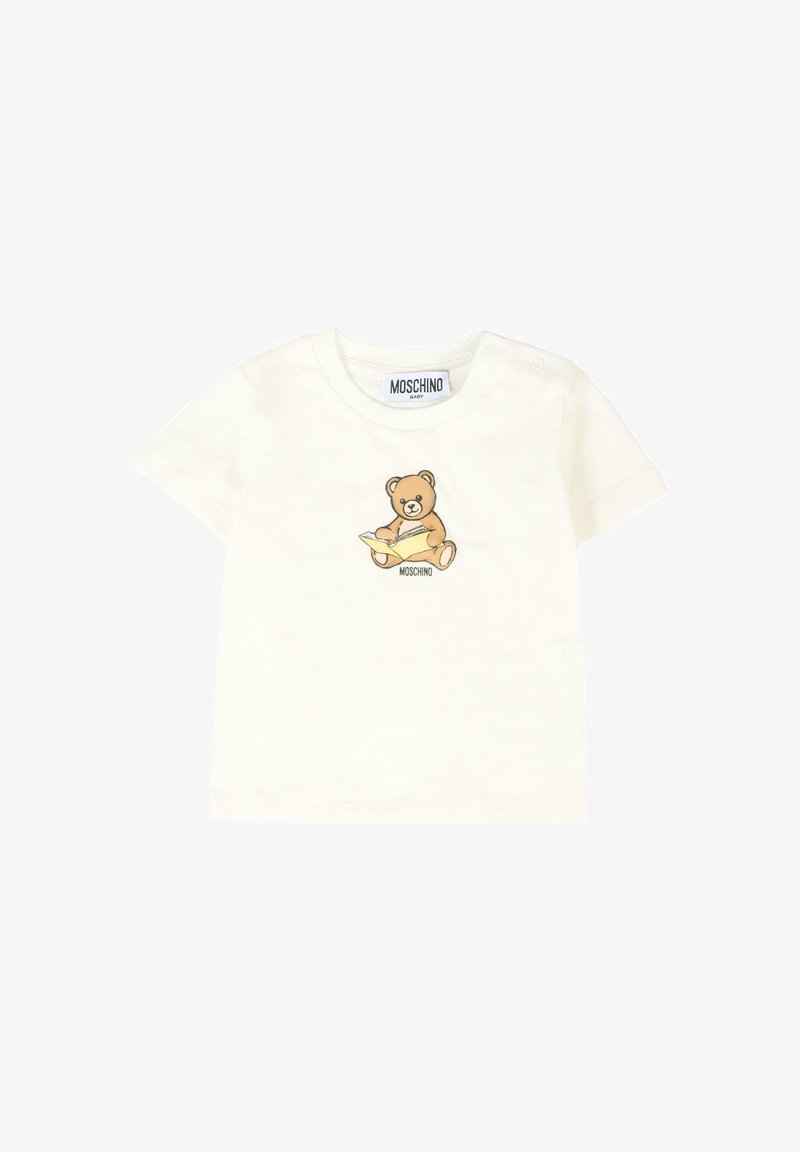 T-shirt en coton blanc pour bébé à manches courtes, ornée d'un graphique de teddy bear marron tenant un livre avec le texte "MOSCHINO" en dessous.