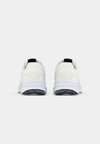 Pair of white athletic shoes with mesh uppers and thick soles shown from the back on a plain white background.