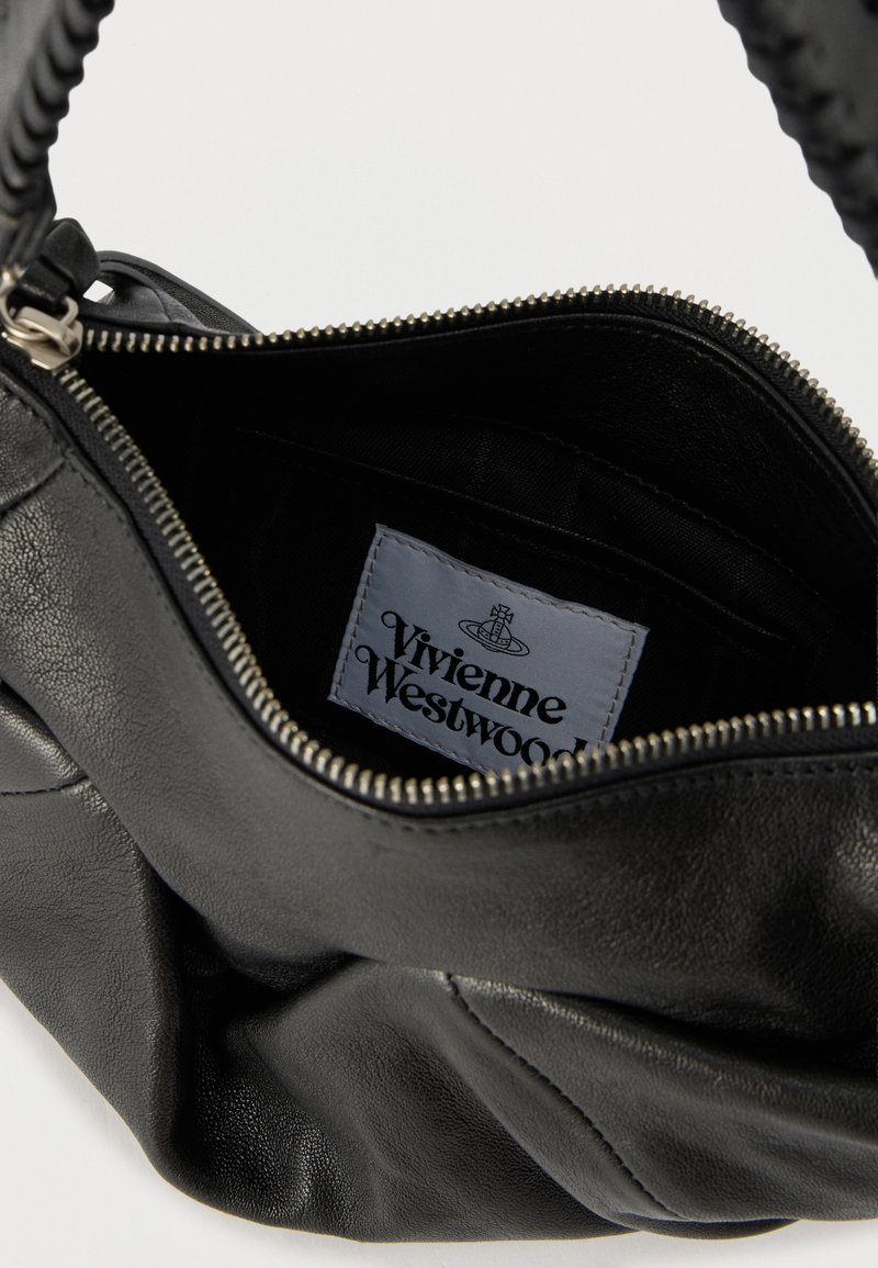 Black leather bag with a braided handle, open zipper showing inside label reading "Vivienne Westwood" on a white patch.