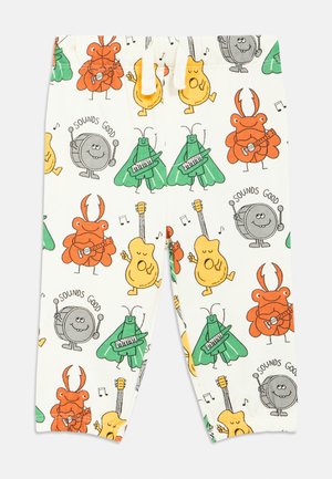 Pantalon blanc avec des insectes colorés en dessin animé jouant de la guitare, du clavier et de la batterie, accompagnés de notes de musique et du texte « Sounds Good ».