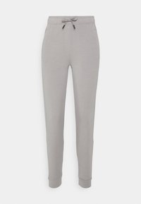 Pantalones de chándal gris claro con cintura ajustable, bolsillos laterales y puños acanalados. Fabricados con una tela suave y de textura lisa.