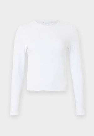 White long-sleeve crew neck slim-fit shirt with simple design, displayed on a plain light gray background.