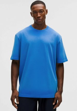 Blauw katoenen T-shirt met korte mouwen, voorzien van een ronde hals en een ontspannen pasvorm. Gladde textuur zonder zichtbare patronen of accenten.