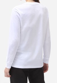 White long-sleeve t-shirt made of cotton, featuring a crew neck and a relaxed fit, with smooth, plain fabric and no visible prints or patterns.