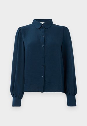 Blouse bleu marine avec un devant à boutons, un col et des manches longues bouffantes. Fabriquée en tissu léger avec une texture lisse.