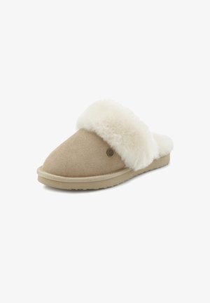 Beige suede slippers with a white fluffy shearling cuff and a flat sole, featuring a small logo detail on the side. Soft texture.