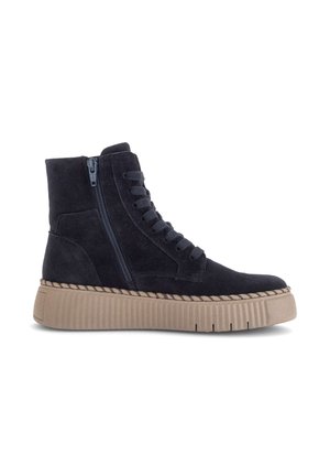 Black suede high-top sneaker with side zipper, black laces, and thick beige ridged rubber sole.