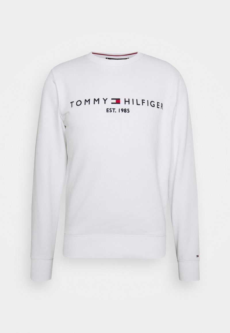 Bílá mikina s dlouhými rukávy. Má logo „TOMMY HILFIGER“, červené a modré akcenty a žebrované manžety a spodní lem. Hladká texturovaná látka.