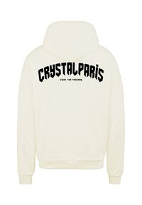 Felpa color crema con cappuccio regolabile. Il retro presenta un testo in bold nero: "CRYSTALPARIS" e "FIGHT FOR FREEDOM" in varie dimensioni.