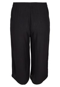 Pantalons courts noirs à coupe ample avec une taille élastique, fabriqués en tissu léger.