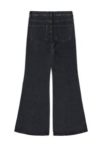 Black flared jeans with a high waist, featuring two back pockets and a smooth texture. The hem is slightly frayed for a casual finish.