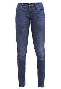 Jeans ajustados de denim azul oscuro, con un diseño clásico de cinco bolsillos, cierre de botón y un sutil desgaste en los muslos.