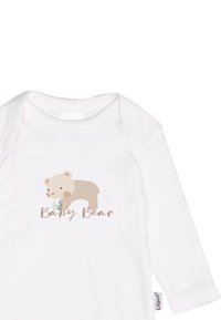 Weißer Langarm-Body mit einem hellbraunen Bärenmotiv und dem Text "Baby Bear" in einer weichen, geschwungenen Schriftart.