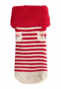 Rot- und cremegestreifte Socke mit einem flauschigen roten Abschluss und einem Bärenkopf-Design. Das Material scheint weich und strukturiert zu sein, geeignet für Komfort.