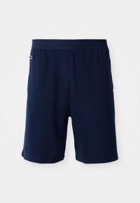 Pantalones cortos azul marino con tejido texturizado, cinturilla elástica con un logo en relieve y un pequeño emblema bordado en la pierna izquierda.