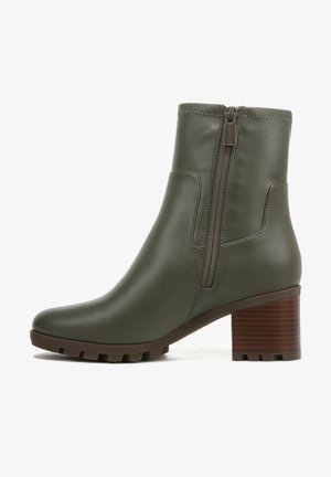 Olive green leather ankle boot with a chunky brown block heel and a side zipper. Smooth texture with a sleek design. Rubber sole for grip.