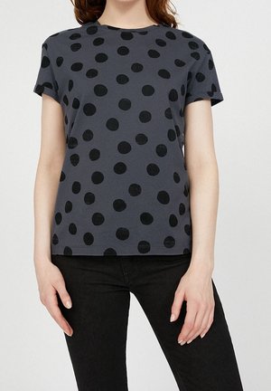 Gray short-sleeve t-shirt featuring large black polka dots. Round neckline, relaxed fit, made from soft cotton material.