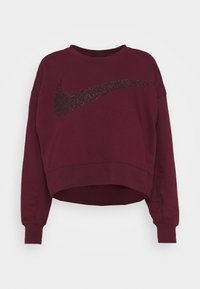 Bordó zkrácená mikina s dlouhými rukávy a velkým černým třpytivým logem Nike ve tvaru swoosh přes hrudník.