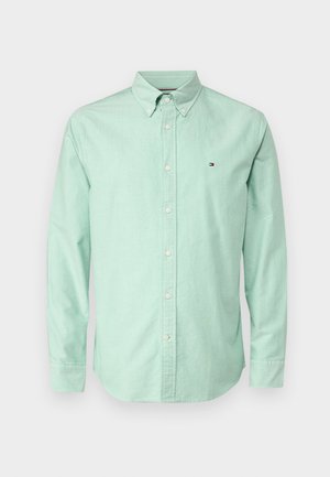 Mint green shirt made of cotton, featuring a classic collar, long sleeves, and front buttons. Small logo on the chest, smooth texture.