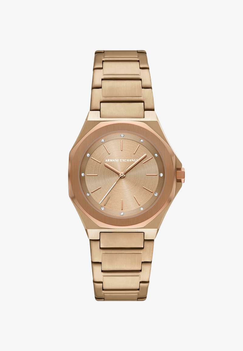 Montre octogonale dorée avec un bracelet en métal brossé. Le cadran présente une finition en or rose et des marqueurs d'heure argentés avec des accents en cristal.