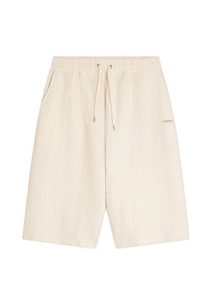 Shorts en maille couleur crème avec taille élastique, cordon de serrage à l'avant et poches latérales.