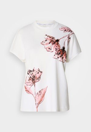 White cotton t-shirt featuring pink floral prints on one side, short sleeves, a round neckline, and a relaxed fit.