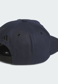 Navy blue baseball cap with a rounded crown, adjustable strap, and black ventilation holes. Features three black stripes on the back.