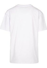 T-shirt blanc uni à manches courtes, vu de dos avec un col rond et une coupe décontractée sur fond blanc.