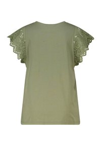 T-shirt vert olive à manches courtes avec des découpes au laser en forme de fleurs, col rond et coupe décontractée. Tissu en coton doux.