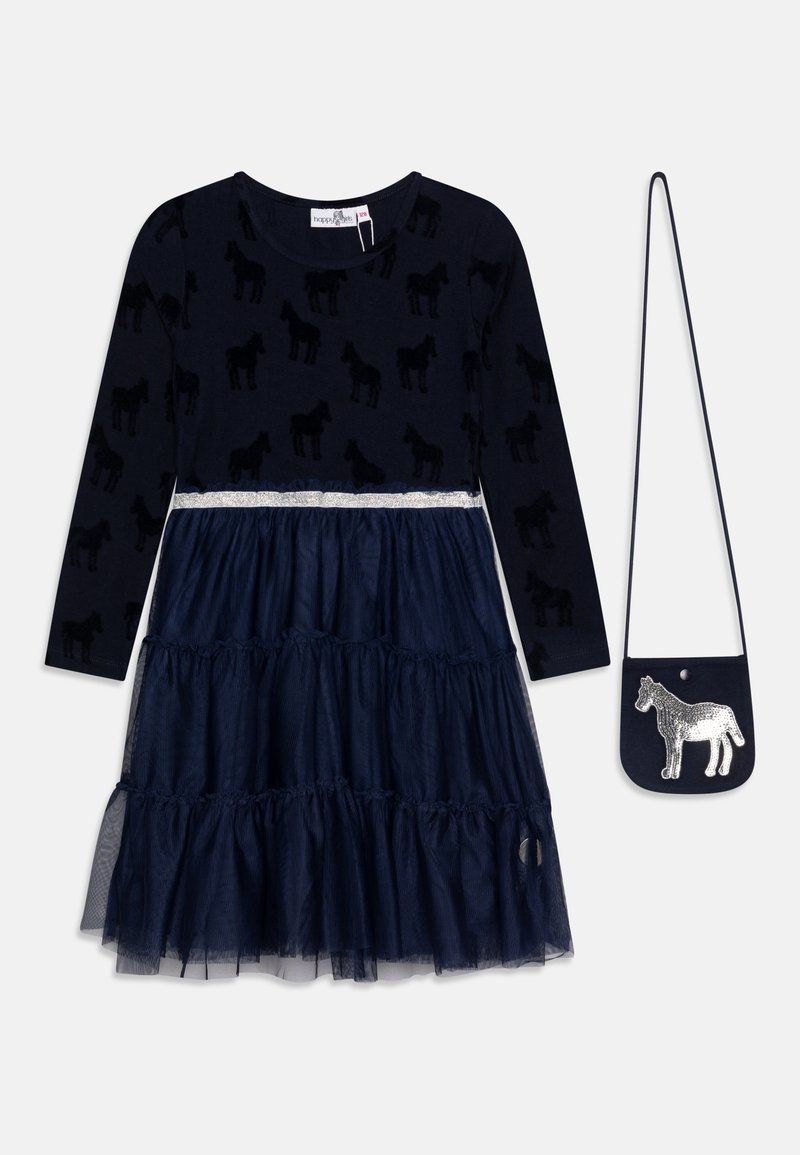 Granatowa sukienka z długim rękawem, z warstwową spódnicą z tiulu, wzorem konia na górze oraz dopasowaną małą torebką na ramię z srebrną łatką w kształcie konia.