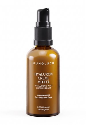 Amberfarbene Glas-Pumpflasche mit der Aufschrift Junglück Hyaluron Creme Mittel mit Hyaluronsäure und biologischem Arganöl für ausgewogene Feuchtigkeitspflege.