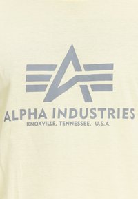 Alpha Industries Triko s potiskem - retro yellow
