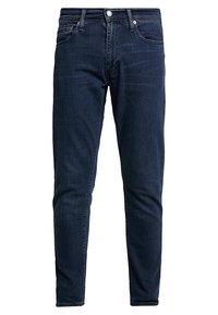 Mörkblå denimjeans med smal passform, som har fem fickor, dragkedja, metallknapp och diskret blekning längs låren.