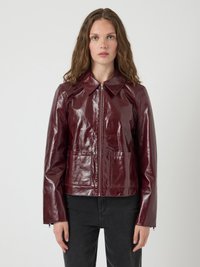 Glossy burgundy leather jacket with a collared neckline, front zip closure, and two patch pockets; fitted design with long sleeves.